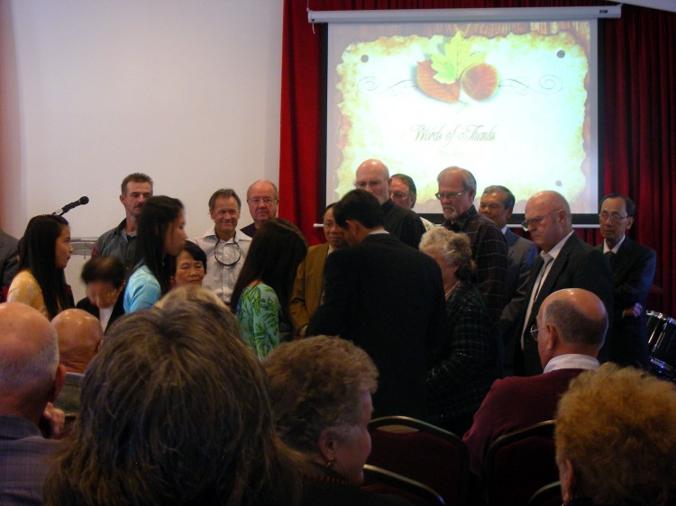 Pastor Simon hands out the medals.