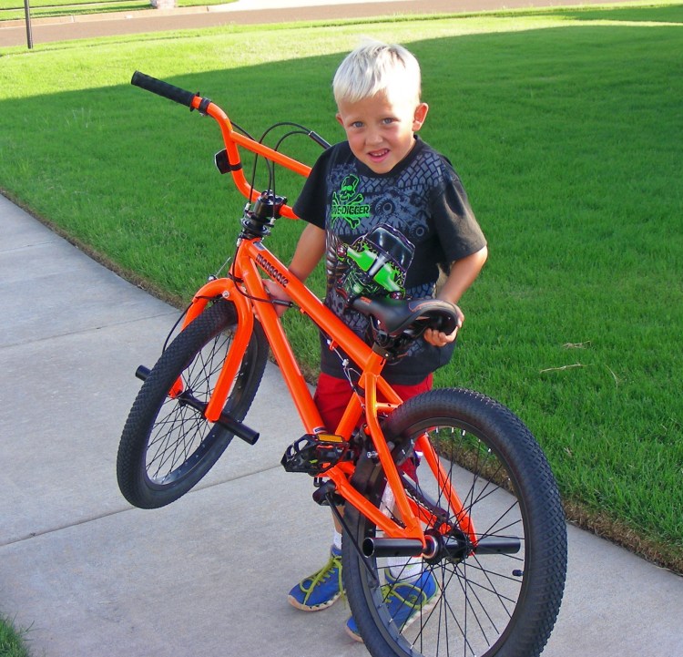 Leo with his new bike. His Dad and I had to cut it down to size, and after just a short time he was riding like a pro...