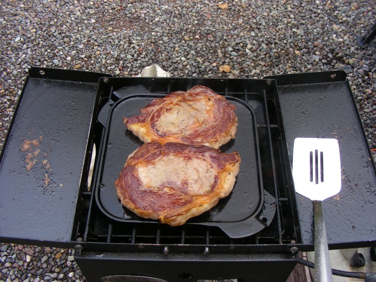 A pair of rib eyes that were cut to Norm's specs. We eat good....