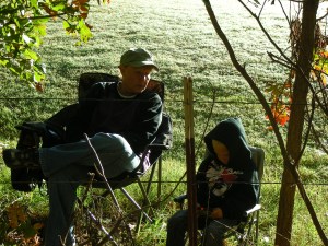 Norm and Leo wait for the first riders into the pit area. Leo got lots of thumbs-ups,  waves and a few wheelies from some of the racers...