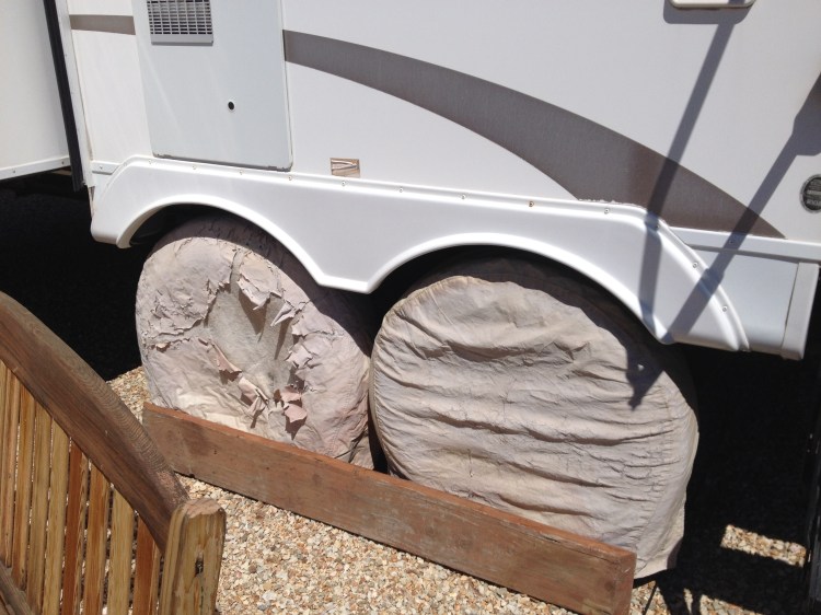 Under neath those worn wheel covers and behind the two by eight are two brand new tires (both sides), axles serviced for the tow to Oklahoma...